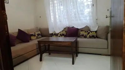 a living room with a couch and a table at tranquil harmony in Casablanca