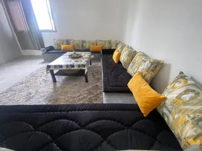 a living room with a couch and a table at Marbella beach appart de standing in Mansouria