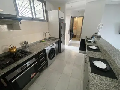 a kitchen with a sink and a washing machine at Marbella beach appart de standing in Mansouria
