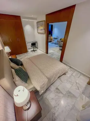 a bedroom with a large bed and a living room at Studio Haven in the Old Medina in Casablanca