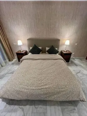 a bedroom with a large bed with two lamps on tables at Studio Haven in the Old Medina in Casablanca