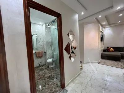 a bathroom with a toilet and a glass shower at Dar MAKTOUBE in Mohammedia