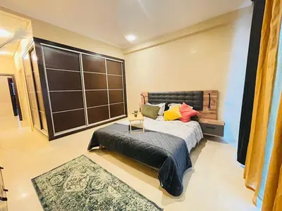 a bedroom with a large bed and a table at Un bijou d'élégance au coeur du quartier Racine de Casablanca in Casablanca