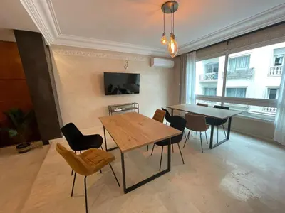 a dining room with a table and chairs at Un bijou d'élégance au coeur du quartier Racine de Casablanca in Casablanca