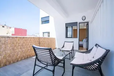 three chairs sitting on top of a balcony at Cosy 80 m2 with 2 balcony 5min Hassan 2 in Casablanca