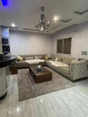 a living room with a couch and a table at Appartement meublé à louer Rabat in Rabat