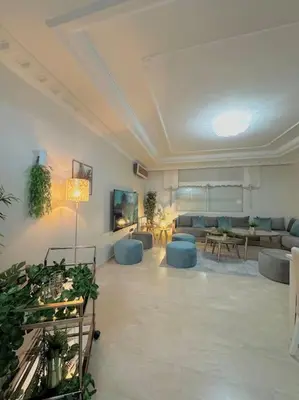 a large living room with couches and plants in it at Lilias Appart - 2 Mars in Casablanca