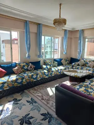 a large living room with a couch and a table at Appartement moderne vue sur mer in Casablanca