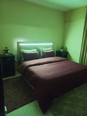 a bedroom with a large bed with purple sheets and pillows at Appartement moderne vue sur mer in Casablanca