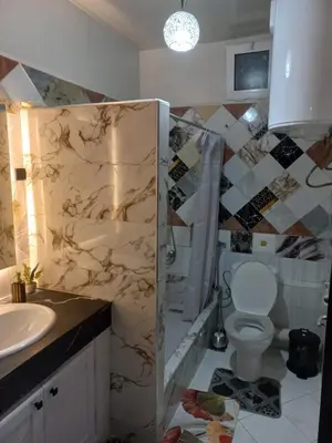 a bathroom with a shower and a toilet and a sink at Appartement moderne vue sur mer in Casablanca