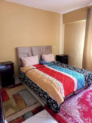 a bedroom with a bed with a colorful comforter at Appartement moderne vue sur mer in Casablanca