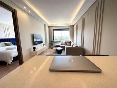 a living room with a laptop on a table at Luxueux studio, vue dégagée in Casablanca