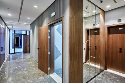 a hallway with wood panels and glass doors at Charming 1 Bed Casablanca Retreat With Free Parking in Casablanca