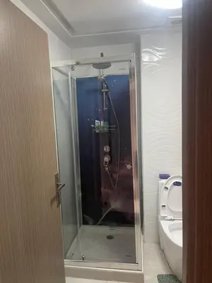 a glass shower in a bathroom with a toilet at Marbella Beach Almansouria in Mansouria