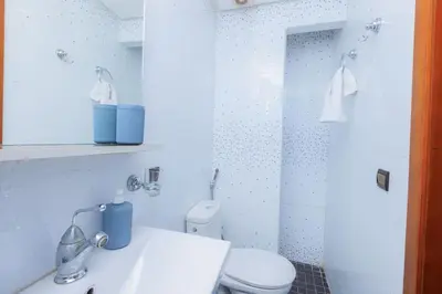 a bathroom with a shower and a toilet and a sink at Chic & Spacious : 3BR Apartment in Central Rabat in Rabat