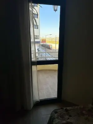 a room with a door open to a parking lot at appart casa voyageurs belvédère in Casablanca