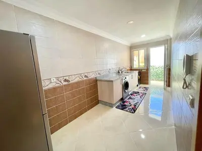 a kitchen with a washer and dryer in a room at F4 Appartement entièrement neuf au cœur de Témara in Temara