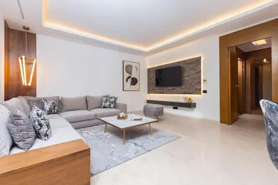 a living room with a couch and a tv at Aristocratic Abode: Luxurious 2BR Flat in Agdal in Rabat