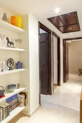 a hallway with white shelves and a door at Luxurious apartment, European Quality in Casablanca
