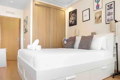 a large white bed in a room with pictures on the wall at BeachSide marvel in Casablanca