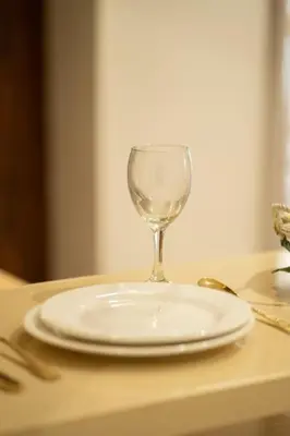 a plate and a wine glass sitting on a table at #3 New Upscale flat in new building in Casablanca