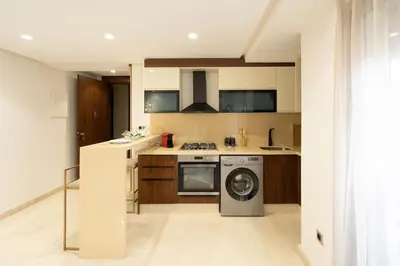 a kitchen with a stove and a washing machine at #3 New Upscale flat in new building in Casablanca