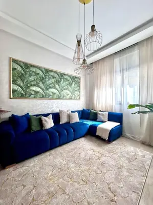 a blue couch sitting in a living room at Appartametno moderno centro di casa in Casablanca