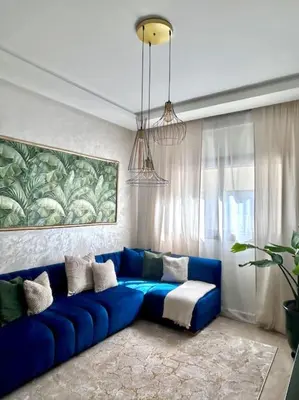 a blue couch sitting in a living room at Appartametno moderno centro di casa in Casablanca