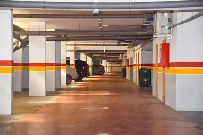 an empty parking garage with cars parked in it at Luxurious Apt - Sea View in Pont Blondin