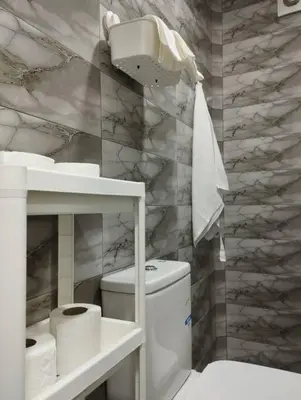 a white bathroom with a toilet and a sink at Mohammedia Relax in Mohammedia