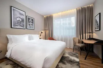 a hotel room with a large bed and a desk at Radisson Hotel Casablanca Gauthier La Citadelle in Casablanca