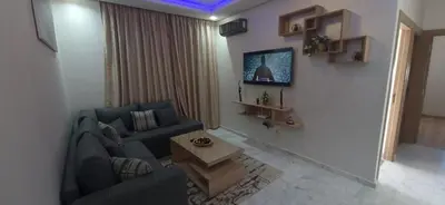a living room with a couch and a table at Zenata ocean park appartement in Mohammedia