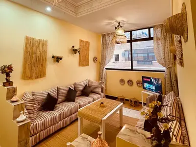 a living room with a couch and a table at Magnificent studio for two in the center of Casablanca in Casablanca