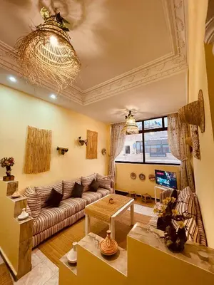 a living room with a couch and a table at Magnificent studio for two in the center of Casablanca in Casablanca