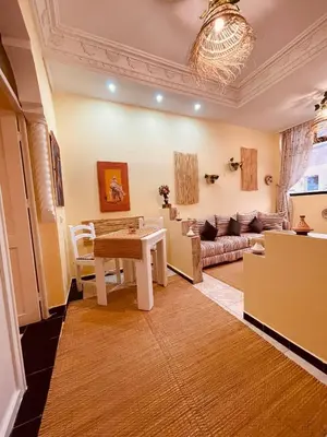 a living room with a table and a couch at Magnificent studio for two in the center of Casablanca in Casablanca