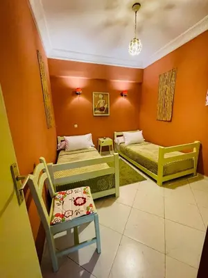 a room with two beds and a chair in it at Beautiful Studio in the heart of Casablanca in Casablanca