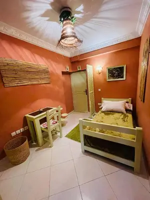 a bedroom with a bed and a table and a ceiling at Beautiful Studio in the heart of Casablanca in Casablanca