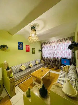 a living room with a couch and a table at Charming Getaway in Casablanca Maroc, Cozy Home with Thoughtful Amenities in Casablanca