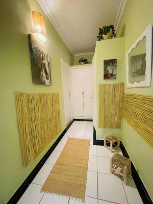 a living room with green walls and white tile floors at Charming Getaway in Casablanca Maroc, Cozy Home with Thoughtful Amenities in Casablanca