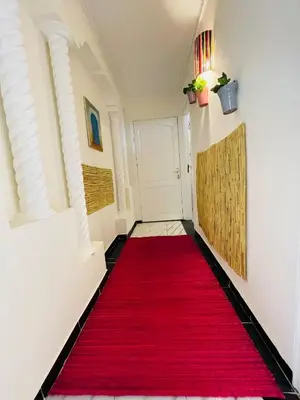 a red carpet in a hallway with a red rug at Coquet Appartement Casablanca in Casablanca