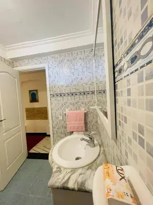 a small bathroom with a sink and a toilet at Coquet Appartement Casablanca in Casablanca