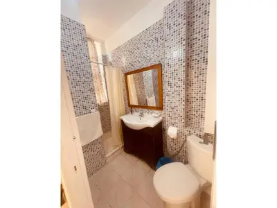 a bathroom with a sink and a toilet and a mirror at Charming Studio In Casablanca in Casablanca