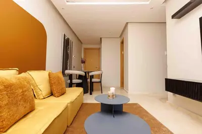 a living room with a couch and a table at Stylish 1BR flat in Hay Riad Central Rabat in Rabat