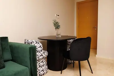 a living room with a table and two chairs at Central Charm: 1-Bed Apartment in Hay Riad in Rabat