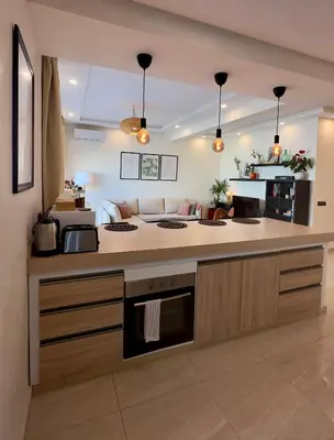 a kitchen with a counter with a stove top oven at Cozy 2 bedrooms flat at Dar Bouazza in Dar Bouazza