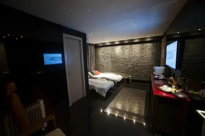 a room with a bedroom with a bed and a table at Casablanca Suites & Spa in Casablanca