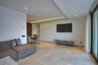 a living room with a couch and a flat screen tv at Appart en face de la tour CFC in Casablanca