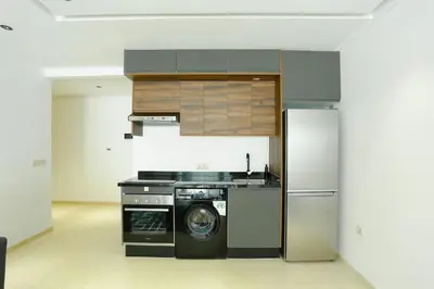 a kitchen with a washing machine and a refrigerator at Serenity in Casablanca