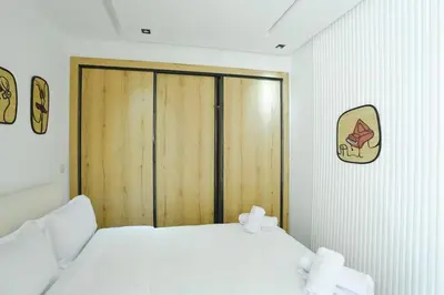 a bedroom with a large wooden door with towels at Serenity in Casablanca