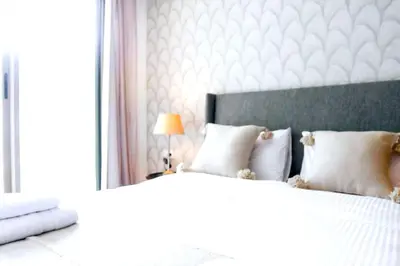 a bedroom with a large bed with white pillows at Waterloo in Casablanca